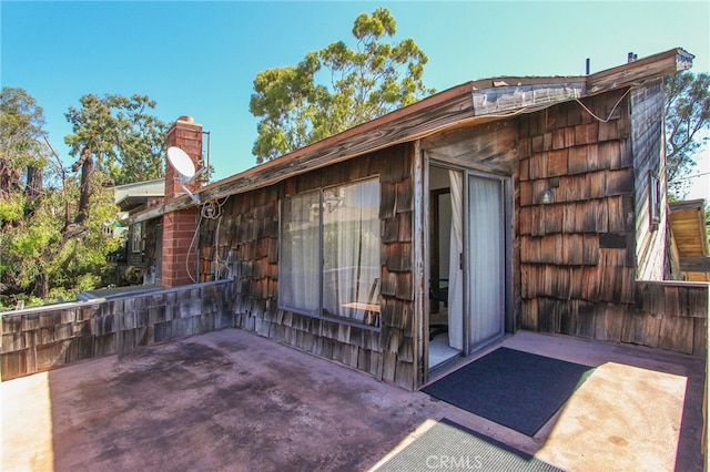 exterior space with a patio and a chimney
