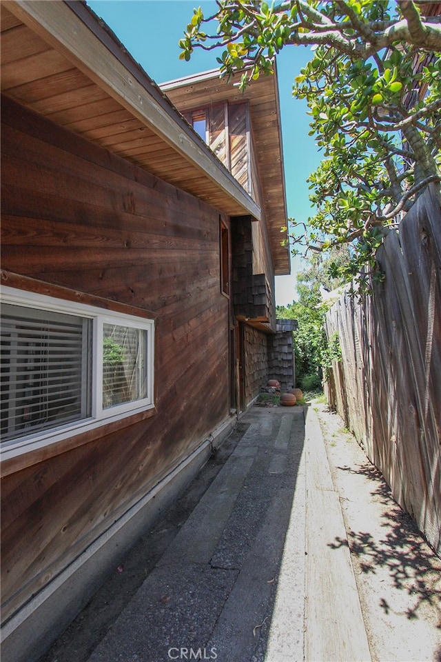 view of side of home with fence