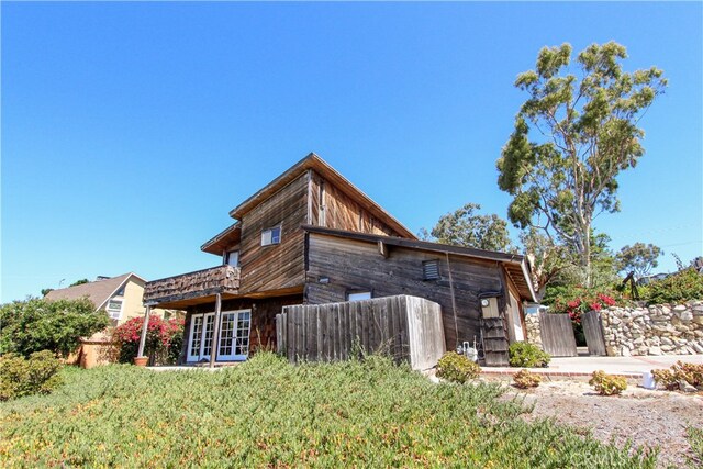 back of house with a lawn