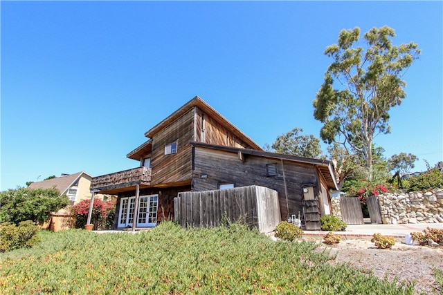 rear view of property featuring fence