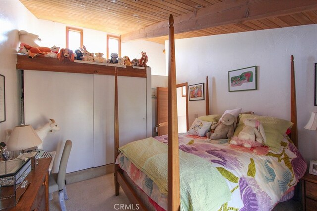 bedroom featuring wood ceiling, beamed ceiling, and carpet flooring