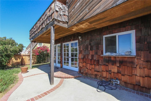 view of patio featuring fence and french doors