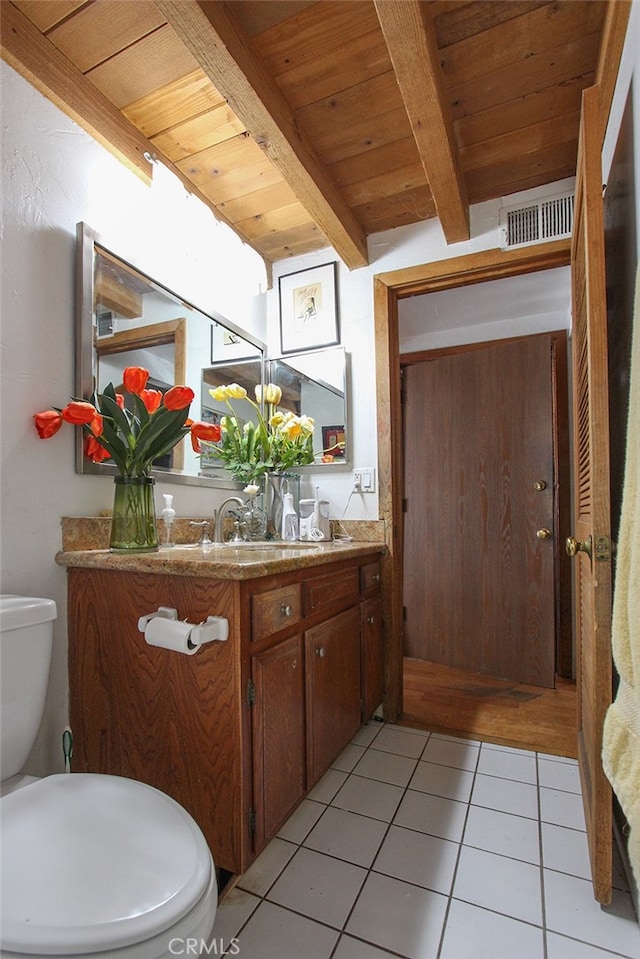 bathroom with vanity, wood ceiling, beam ceiling, tile patterned floors, and toilet