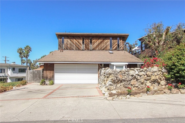 traditional-style house with fence and concrete driveway