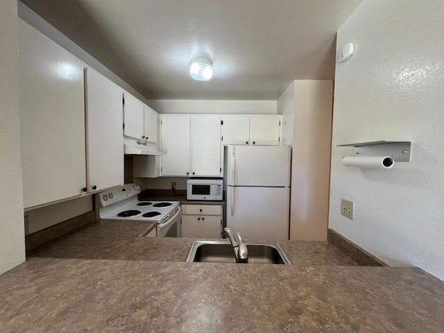 kitchen featuring white cabinetry, sink, and white appliances