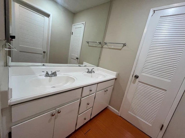 bathroom with hardwood / wood-style flooring and vanity