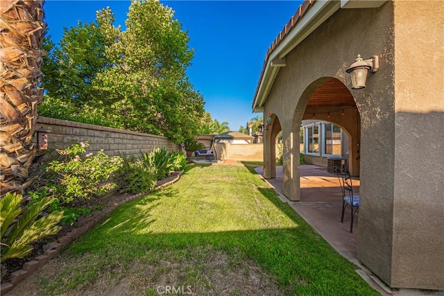 view of yard with a patio area and a fenced backyard