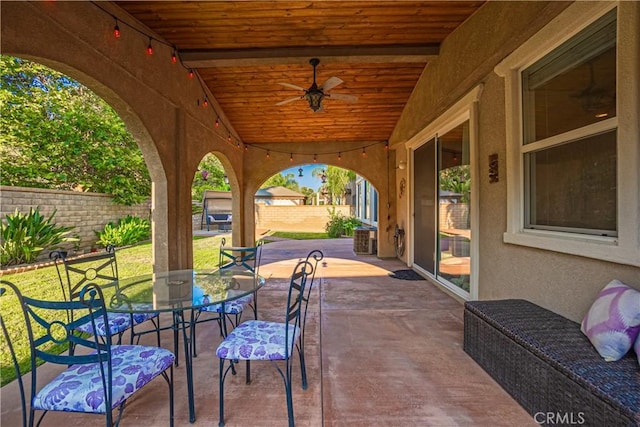 view of patio with ceiling fan, fence, outdoor dining area, and central AC