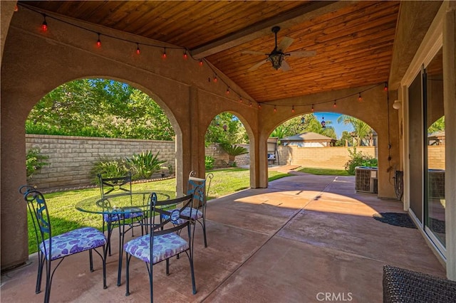 view of patio with a fenced backyard, a ceiling fan, central AC, and outdoor dining space