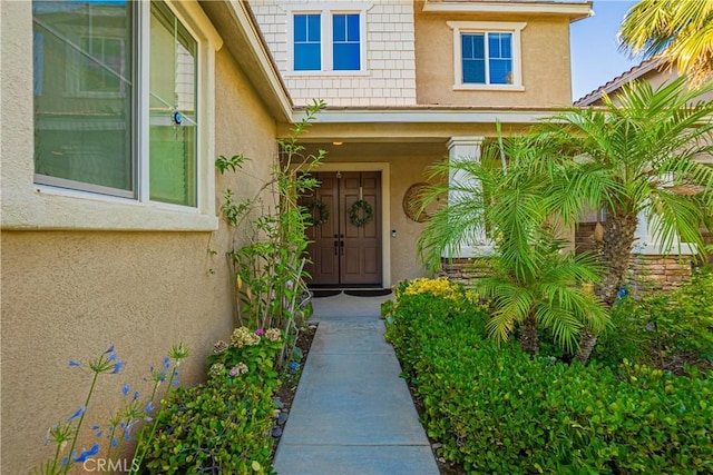 entrance to property featuring stucco siding