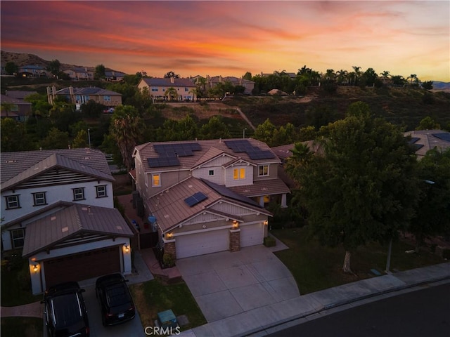 aerial view at dusk featuring a residential view