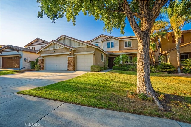 view of front of home featuring a garage, concrete driveway, a front lawn, and stucco siding