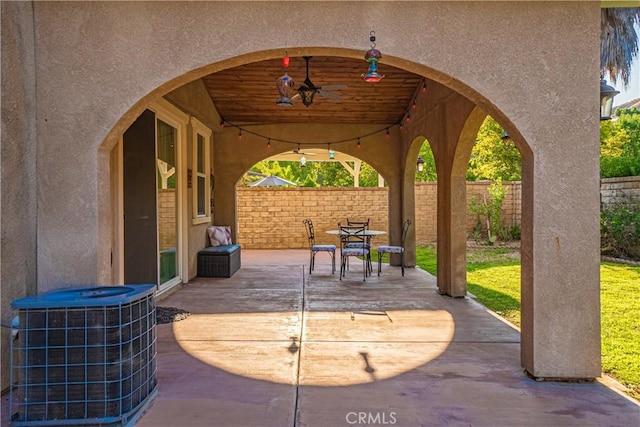 view of patio / terrace with ceiling fan, outdoor dining space, cooling unit, and fence