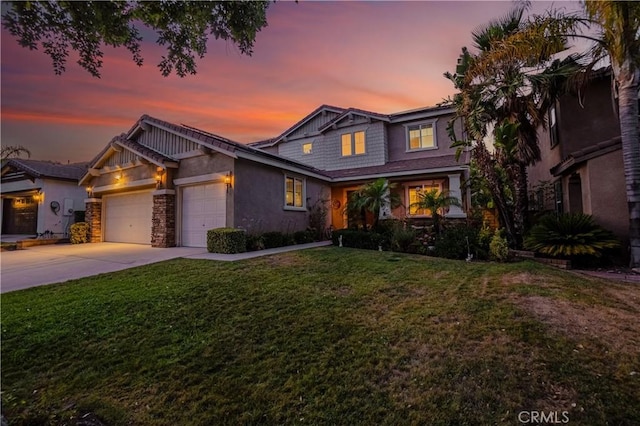 view of front of property with a garage, concrete driveway, a front yard, and stucco siding