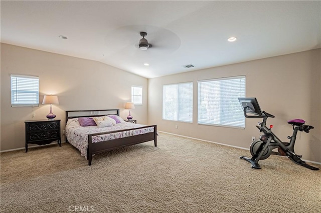 carpeted bedroom featuring lofted ceiling, visible vents, and baseboards