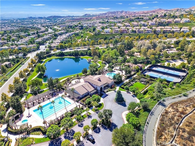 birds eye view of property with a water and mountain view