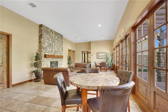 dining room with recessed lighting, baseboards, visible vents, and a stone fireplace