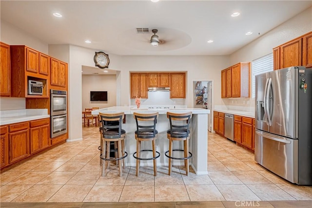 kitchen featuring light tile patterned floors, visible vents, appliances with stainless steel finishes, and light countertops