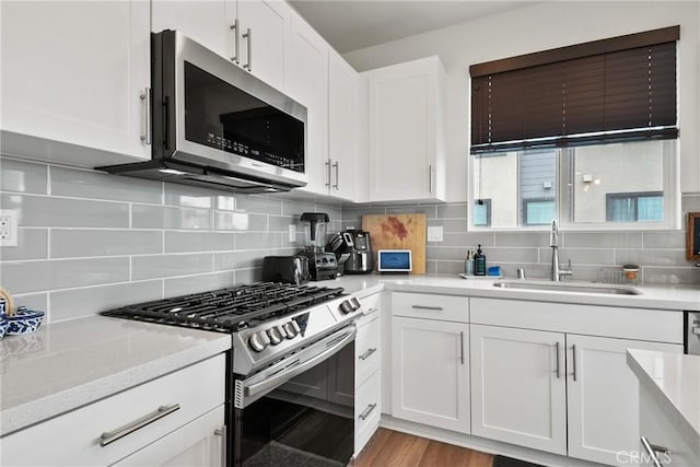 2961 W Lincoln Ave Unit 1, Anaheim, CA 92801 - kitchen with white cabinets, stainless steel appliances, and a sink
