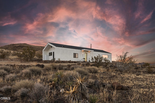 back house at dusk featuring a mountain view