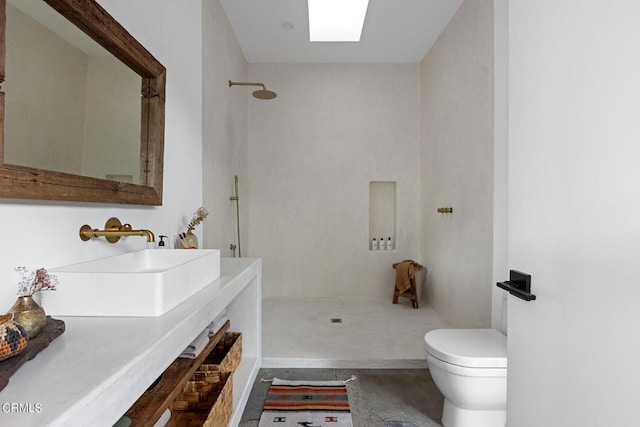 bathroom featuring a shower, vanity, and toilet