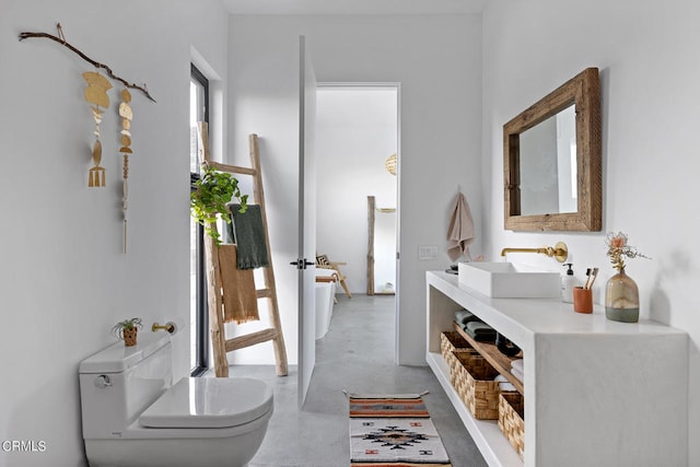 corridor with concrete flooring and sink