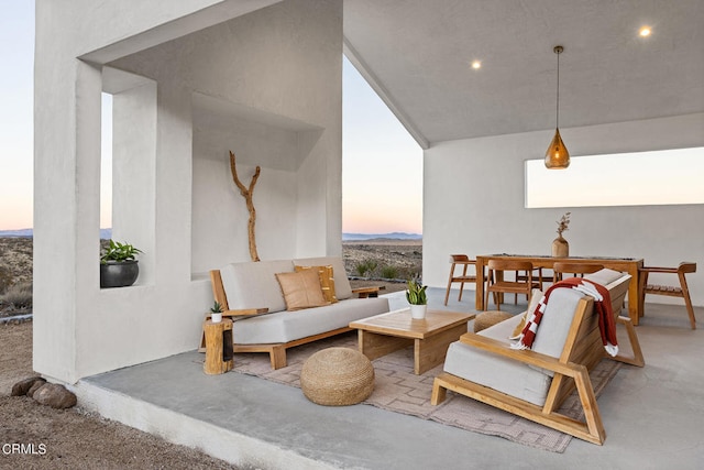 patio terrace at dusk featuring an outdoor hangout area