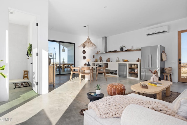 living room featuring a wall unit AC and concrete flooring