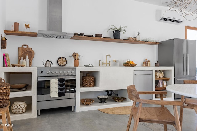 kitchen featuring concrete flooring, appliances with stainless steel finishes, ventilation hood, and an AC wall unit