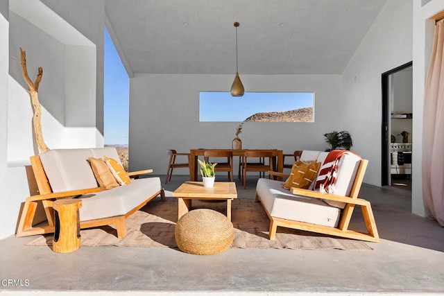 living room with concrete floors and lofted ceiling