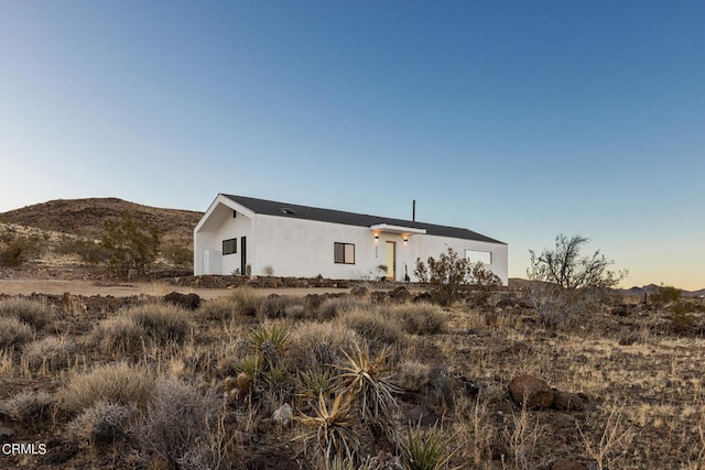 rear view of house featuring a mountain view