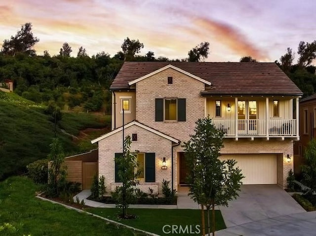 view of front of property featuring a garage and a yard