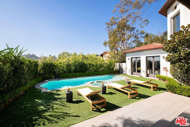 view of pool featuring an outdoor structure and a lawn