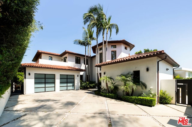 mediterranean / spanish-style house with a garage