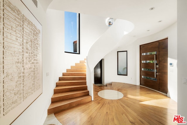 entrance foyer featuring basketball court and wood-type flooring