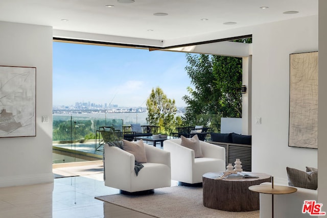 living room with a wealth of natural light and light tile patterned flooring