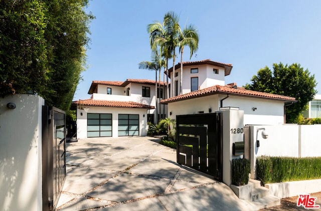 mediterranean / spanish home with a garage