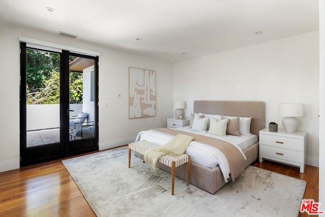 bedroom with access to outside and light hardwood / wood-style floors