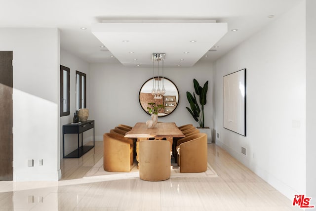 dining room featuring a chandelier and light tile patterned flooring