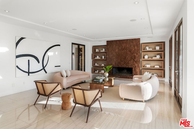 living room with built in shelves, light tile patterned flooring, and a premium fireplace