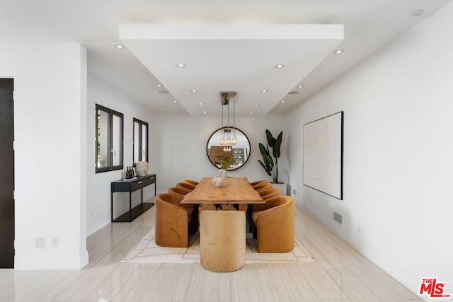 dining area featuring an inviting chandelier