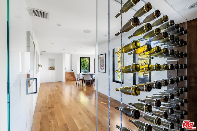 wine room with light hardwood / wood-style floors