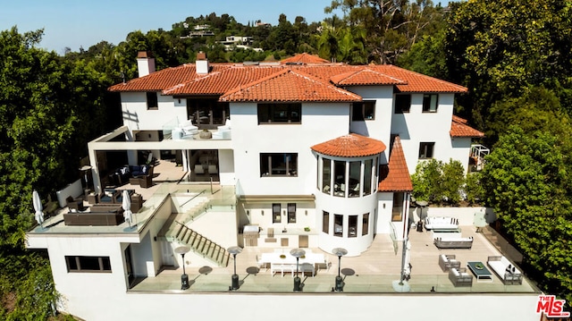 back of property featuring a patio and a balcony