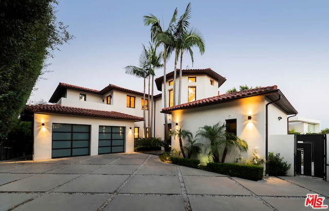 mediterranean / spanish house with a garage