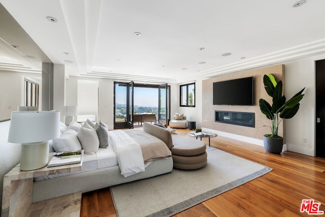 bedroom featuring access to exterior and light hardwood / wood-style floors