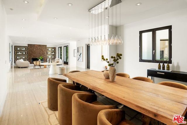 tiled dining space with a large fireplace