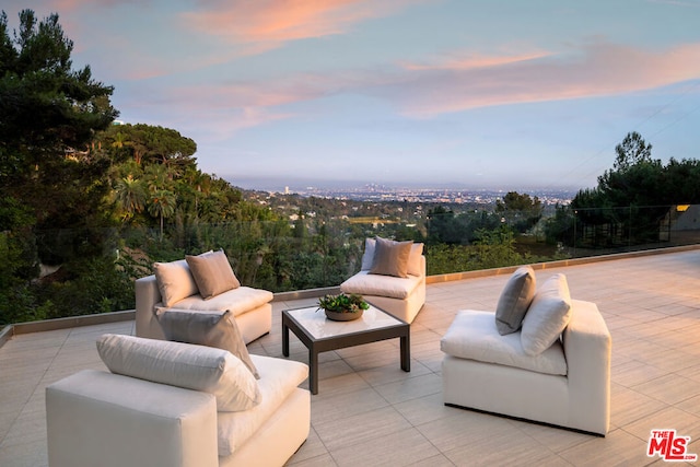 patio terrace at dusk featuring an outdoor living space