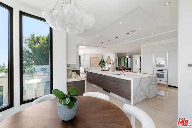 dining room with a notable chandelier and sink