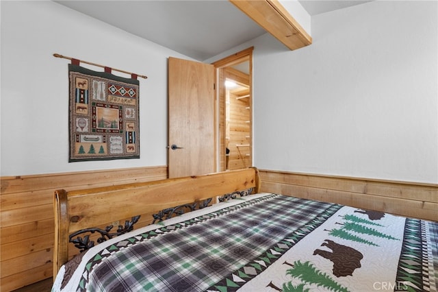 bedroom with wood walls