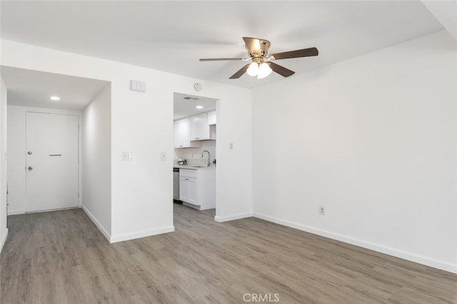 35104 Mesa Grande Dr, Calimesa, CA 92320 - unfurnished living room featuring a sink, baseboards, visible vents, light wood-style floors, and ceiling fan